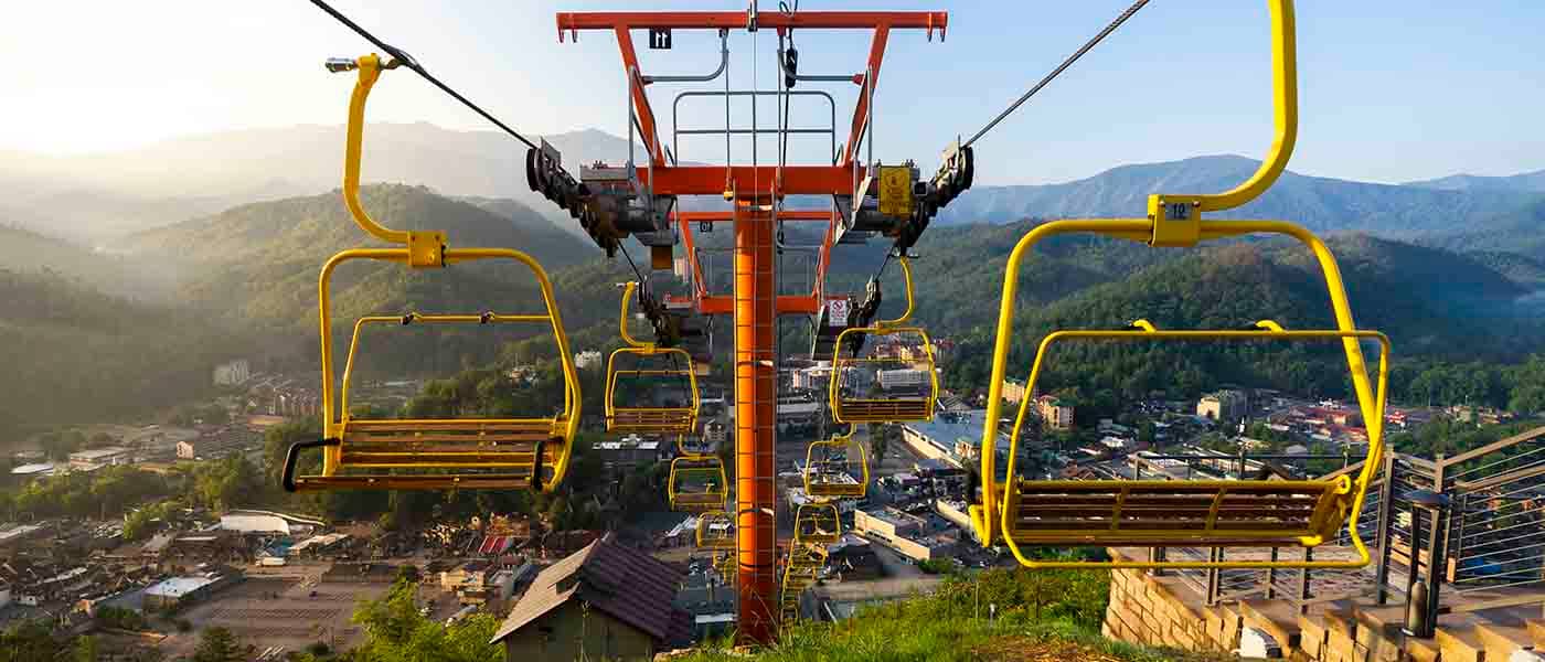 The famous yellow SkyLift chairs with Mount Leconte in the background.